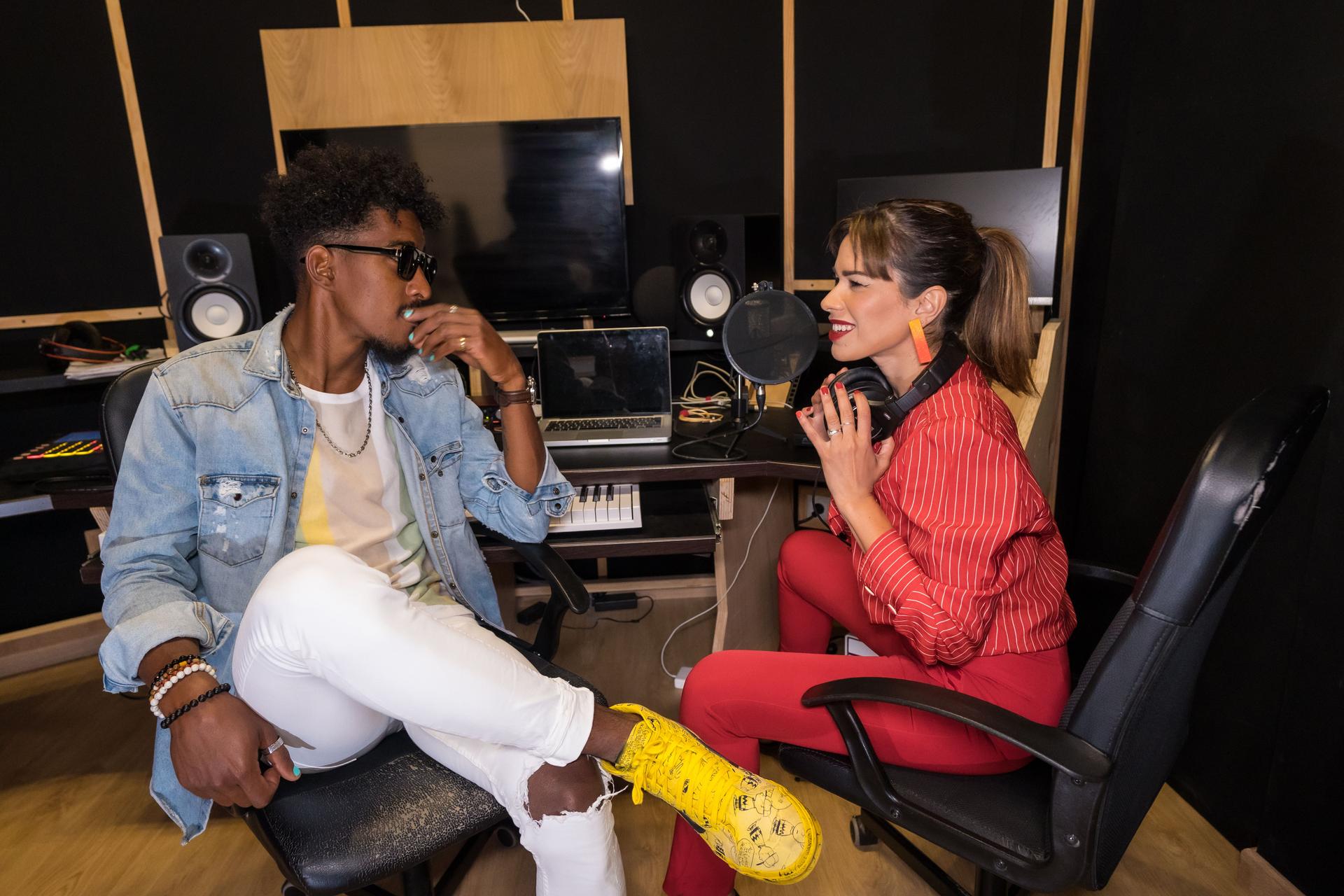 Musicians talking relaxed during a break in a recording studio